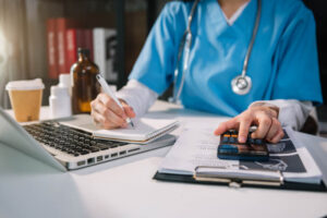 Medical worker computing miscellaneous fees and others.