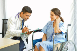 Patient on wheelchair discussing her doctor if she can go to work.