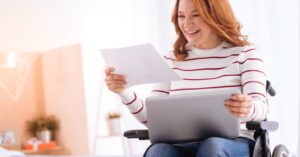 A woman reading a letter from her Denver disability lawyer about her new benefits. 