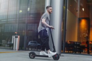 A man is riding an electric scooter in Denver.