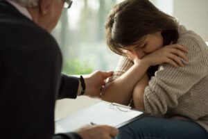 A woman being consoled by The Wilhite Law Firm Thornton personal injury attorney. 