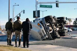 Police officers investigating truck accident.