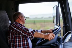 Truck driver looking side ways.