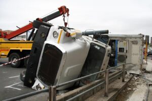 Overturned truck against pedestrian railings