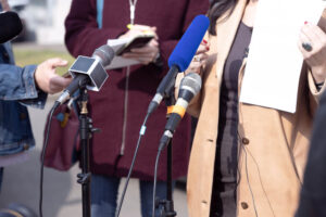 Whistleblower showing documents as evidence being interviewed by the media.