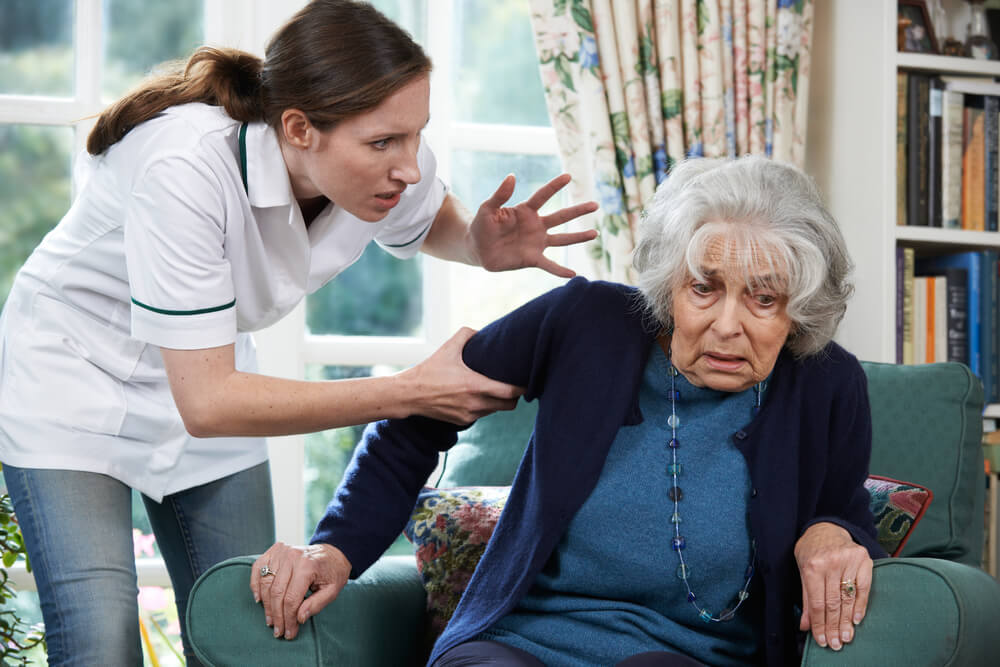 Senior lady feeling threatened by the staff in nursing home care.