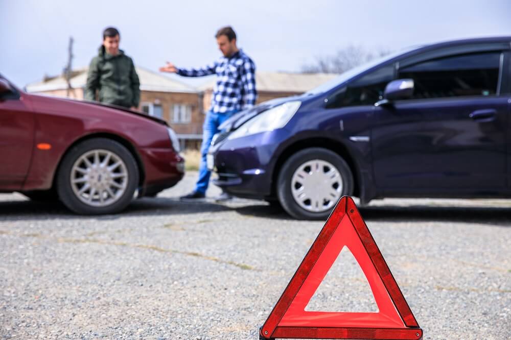 Uninsured driver talking to the driver involved in car accident.