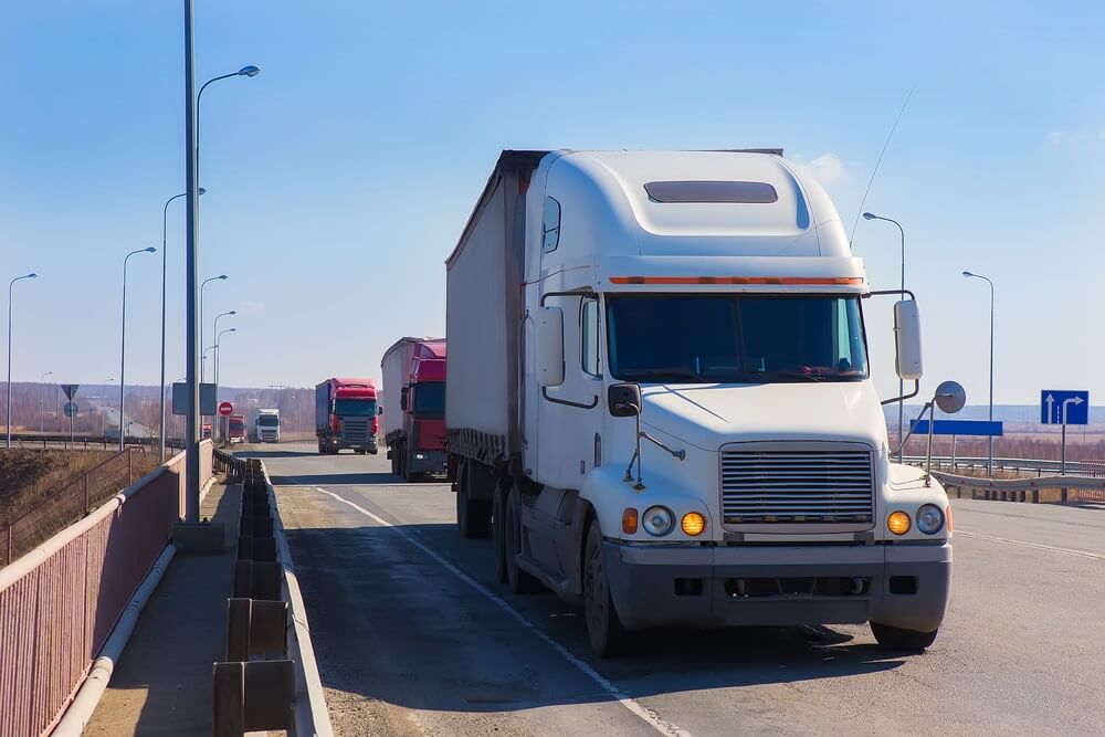 White truck passing the bridge.