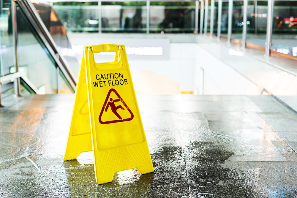 Caution sign wet floor near the stairs