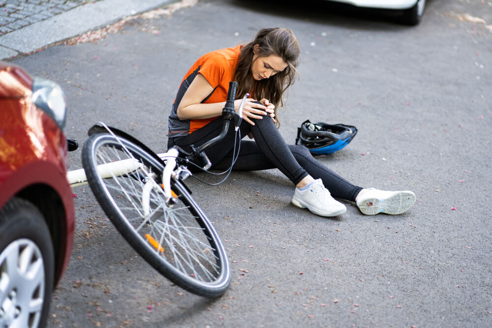 Injured female cyclist hit by a car