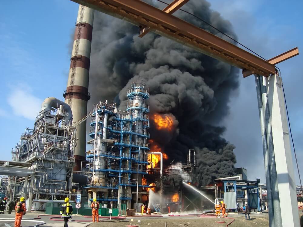 Oil refinery accident explosion with dark smoke