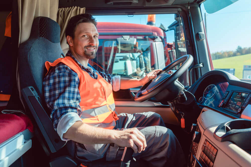 Truck driver smiling while at work.