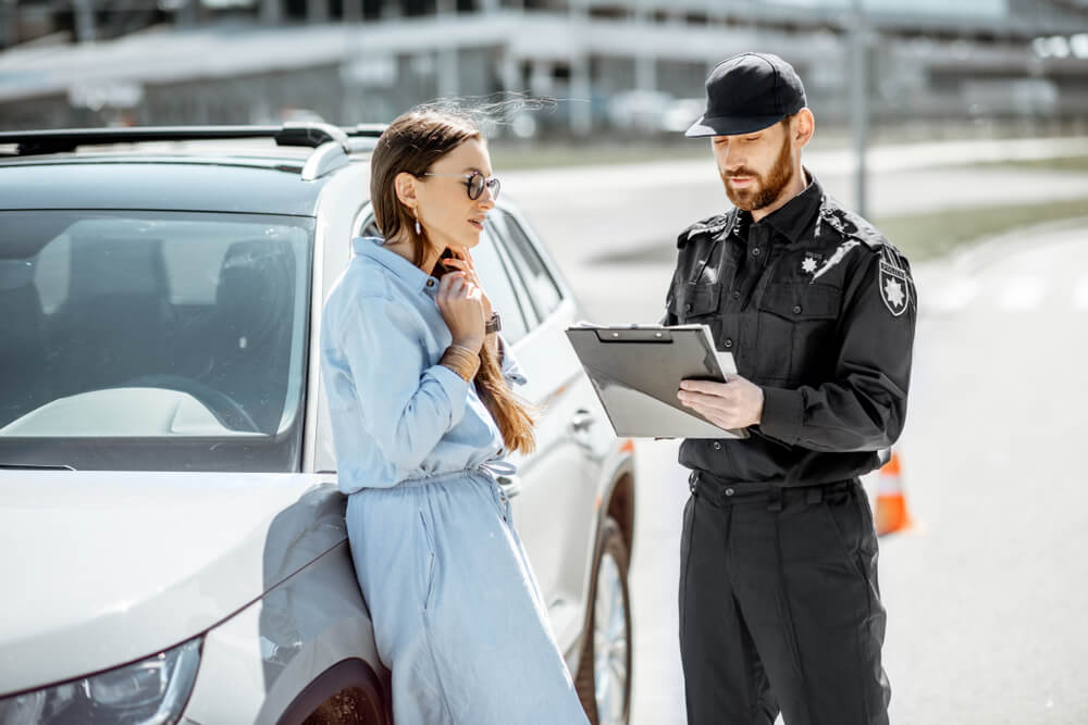 Police checking on lady driver on her license plate violation.